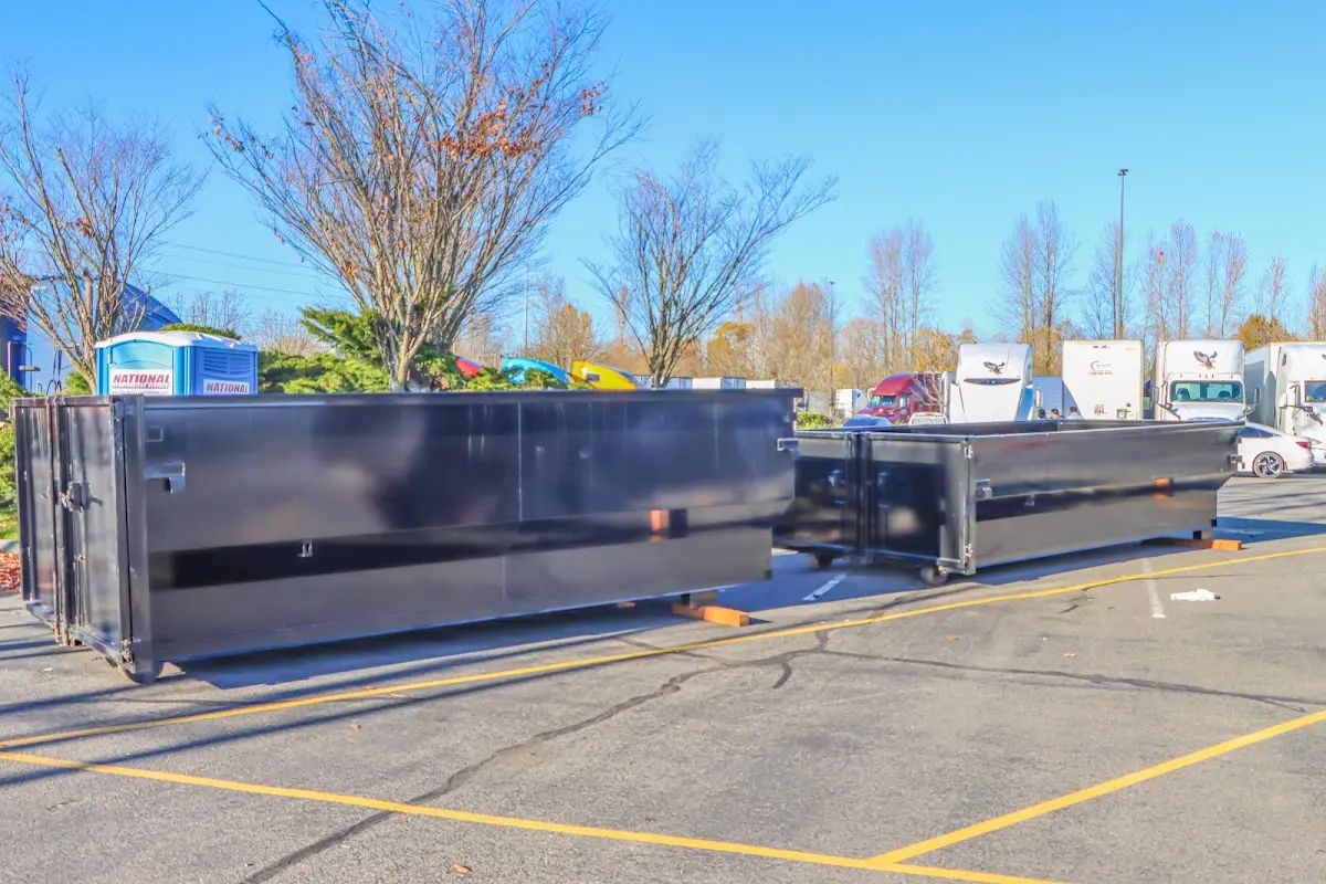 Professional dumpster rental service with roll-off container on residential driveway in Ione